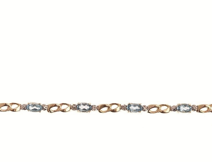 Beautifully Designed 10kt. Gold Bracelet. This design is mounted with Blue Topaz Gemstones, and is accented with Diamonds. The gemstones are approximately 2.30ctw., and the diamonds are approximately 0.02ctw., of I clarity and H-I Color This Bracelet measures approximately 7 inches in length.  For further customization options not shown, please contact us prior to placing your order.  